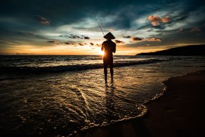 Lone fisherman silhouetted at sunset on Phu Quoc island
