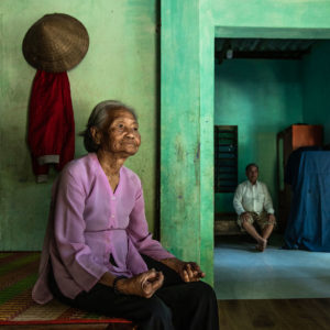 Two figures in Hoi An with green and purple tones