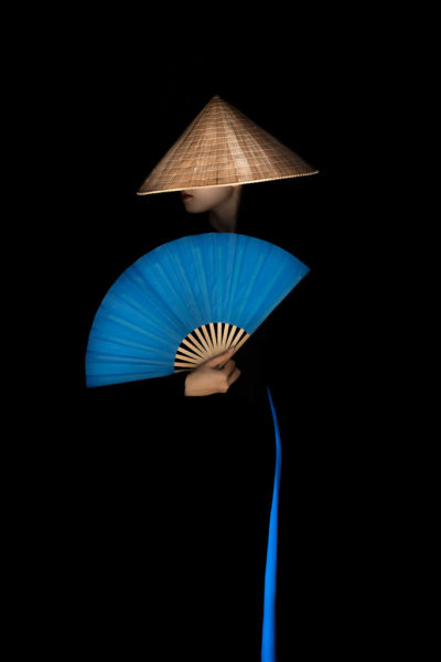 A lady with blue Ao Dai and blue fan in Vietnam